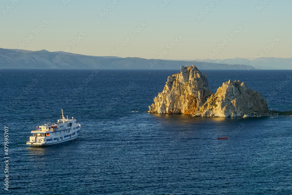 Shaman rock and cruise ship at sunset on Baikal