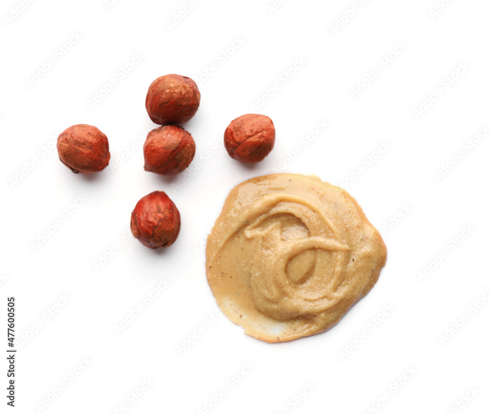 Delicious hazelnut butter and nuts on white background, top view Delicious hazelnut butter and nuts on white background, top view