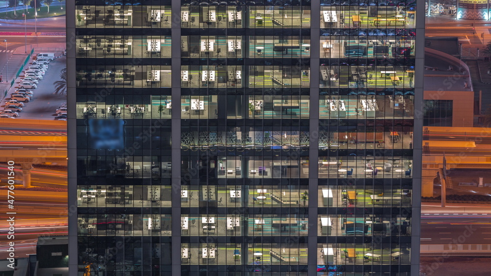 Outside view of windows in offices of a high class building at night timelapse Outside view of windows in offices of a high class building at night timelapse
