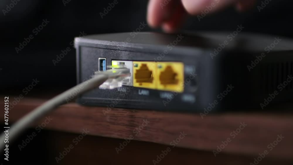 Ethernet cable on the back of the internet router. Wireless Router On The Desk