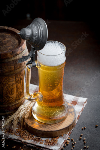 Light beer in a glass, on an old background.