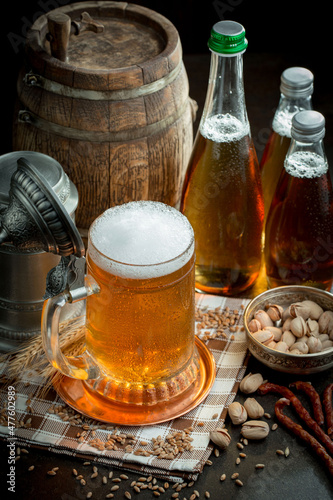 Light beer in a glass, on an old background.
