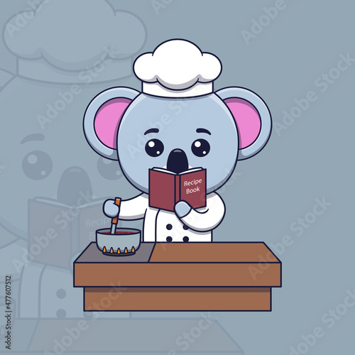 Photography Cute koala chef cooking while looking at the recipe book