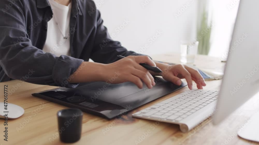 Cropped shot of unrecognizable graphic designer using stylus and drawing tablet for work Cropped shot of unrecognizable graphic designer using stylus and drawing tablet for work