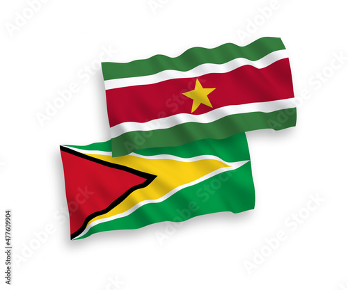 National vector fabric wave flags of Co-operative Republic of Guyana and Republic of Suriname isolated on white background. 1 to 2 proportion.