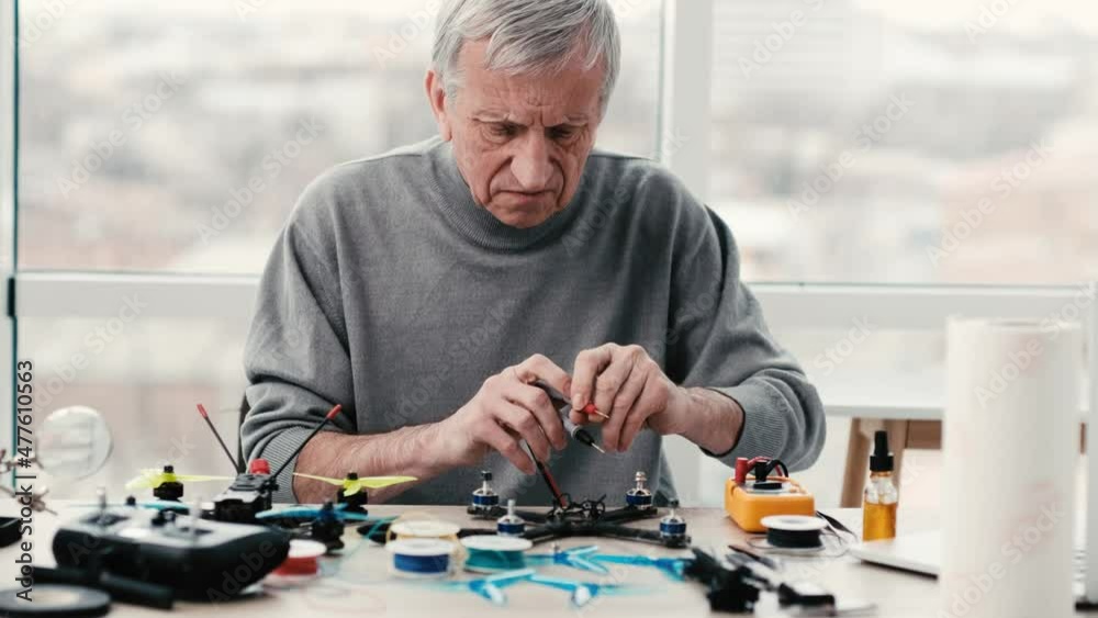 Man engineer repairing quadcopter and check recharge using professional tools Man engineer repairing quadcopter and check recharge using professional tools