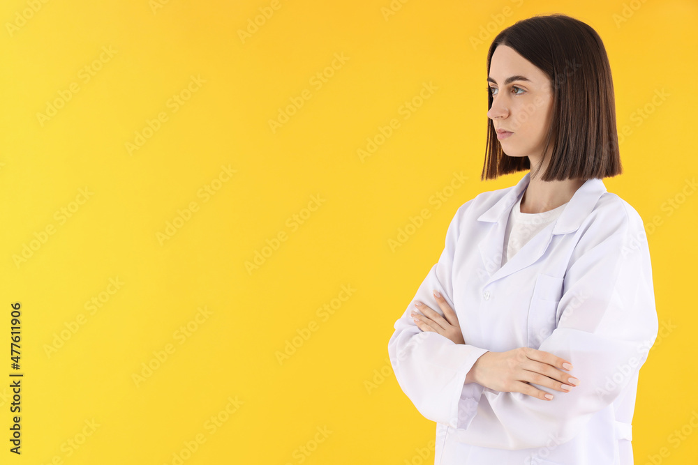 Female doctor on yellow background, space for text Female doctor on yellow background, space for text
