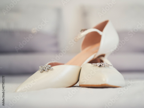 Fotografering White wedding shoes with brooch