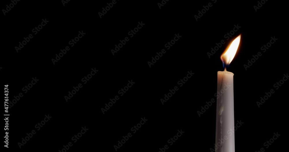 Candle on a black background. The flame of the candle slowly flickers. One candle slowly flickers. Ideal for background or over-layer with blending mode add, screen, lighten. Candle on a black background. The flame of the candle slowly flickers. One candle slowly flickers. Ideal for background or over-layer with blending mode add, screen, lighten.