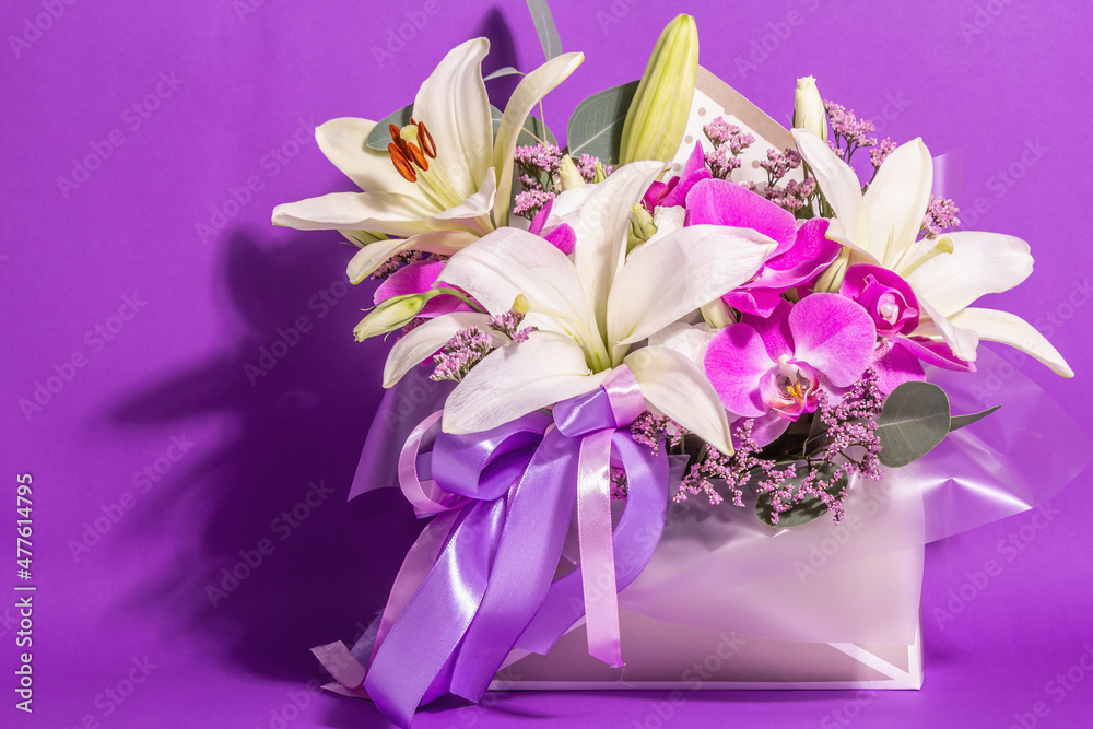 A beautiful bouquet of fresh flowers on a violet background