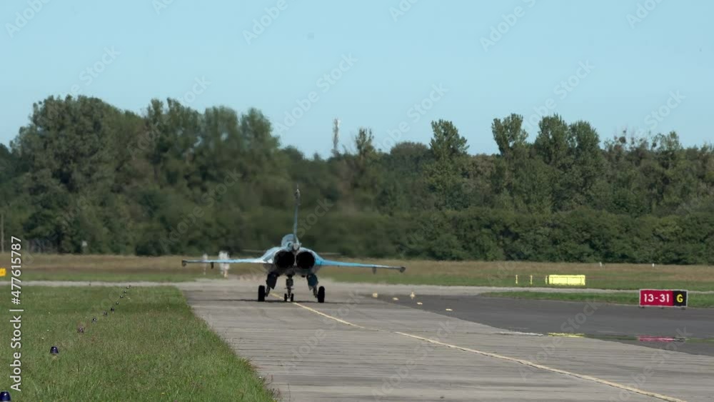 Dassault Rafale fighter jet standing on runway waiting for clearance to take off, heat from engine