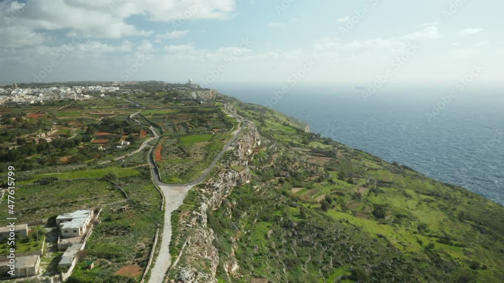 AERIAL: Farmland and Road On Dingli Cliffs with Blue Mediterranean Sea and Clear Sky in Winter AERIAL: Farmland and Road On Dingli Cliffs with Blue Mediterranean Sea and Clear Sky in Winter