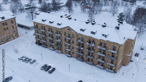 Luxury style apartment building in Swedish town during snowfall, aerial shot photo