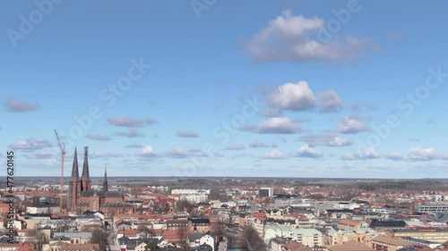 Uppsala city skyline with cathedral in Sweden. Aerial view tilting down photo