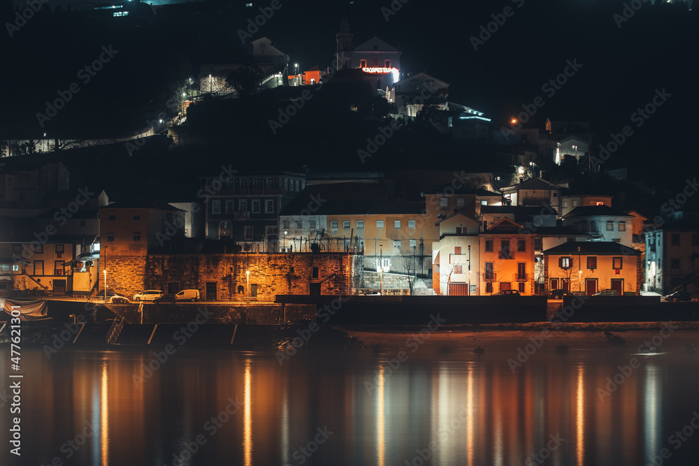 A village near water photographed at night in Portugal