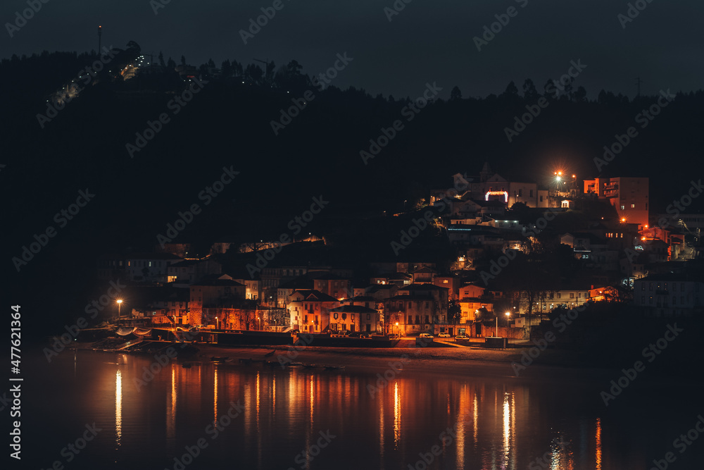 A village near water photographed at night in Portugal A village near water photographed at night in Portugal