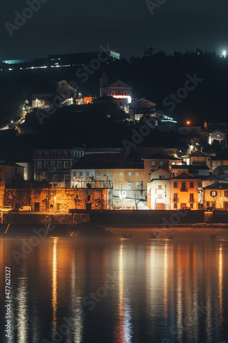 A village near water photographed at night in Portugal