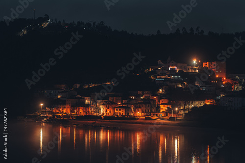 A village near water photographed at night in Portugal © Rafael Machado