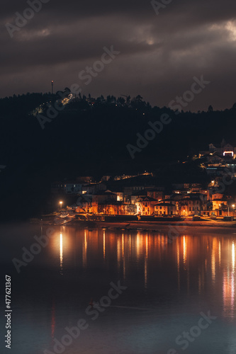 A village near water photographed at night in Portugal