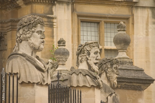 Carved emperor or philosopher heads around the perimeter of the Sheldonian Theatre in Oxford England photo