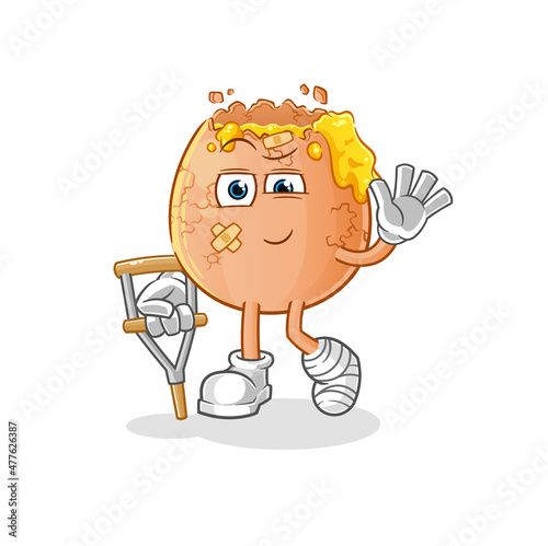 broken egg sick with limping stick. cartoon mascot vector