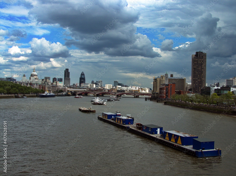 Boats moored in the middle of the Thames, London, United Kingdom.