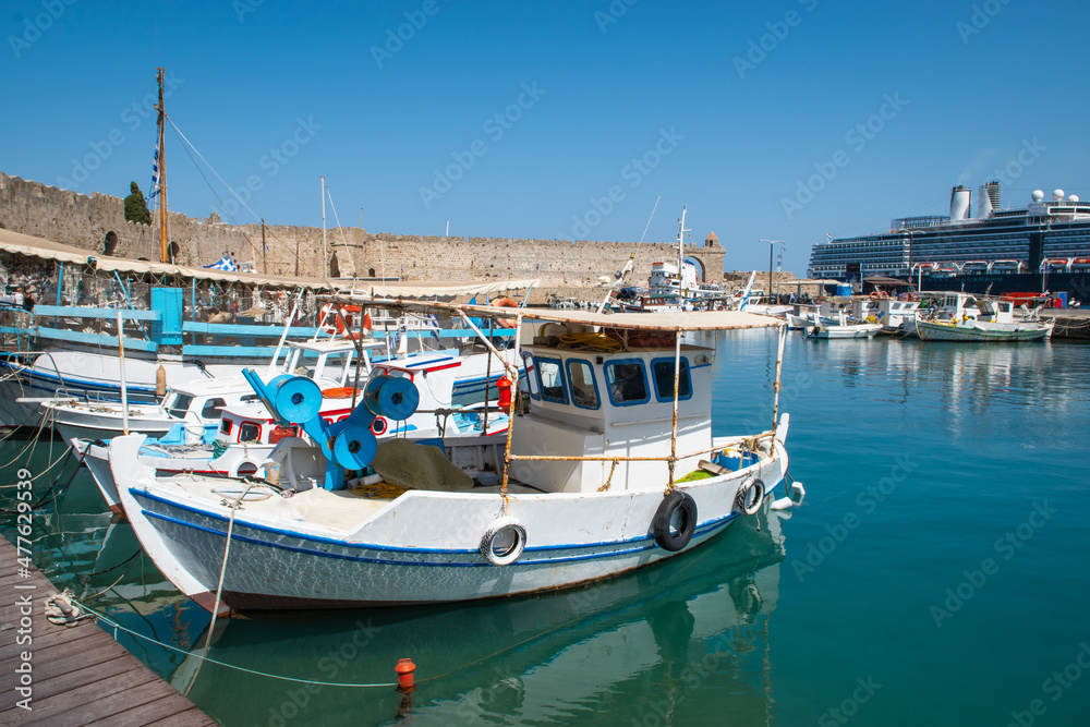 Fishing boat docked in Mandraki harbor of Rhodes, Greece.
