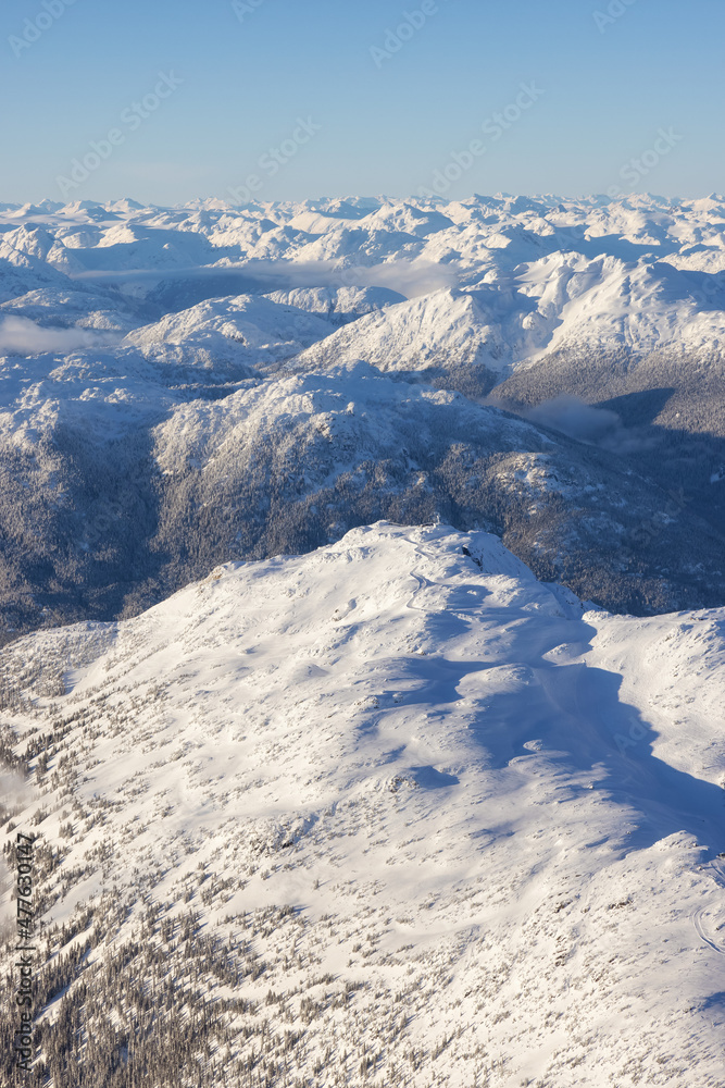Aerial View from an Airplane of Whistler Mountain covered in fresh snow during winter season. British Columbia, Canada. Canadian Nature Landscape Background