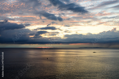 Panorama shots of gorgeous sunset over the Pacific Ocean with puffy rain clouds in the background. 
