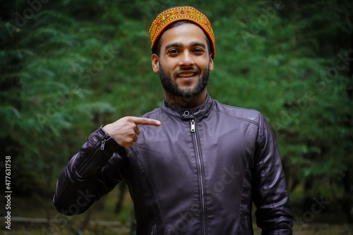 Pointing something a man from Himachal Pradesh in traditional dress photo