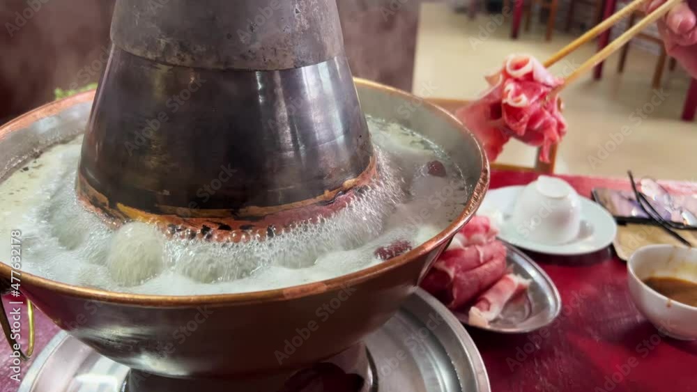 A person is eating hot old Beijing mutton, copper pot mutton A person is eating hot old Beijing mutton, copper pot mutton