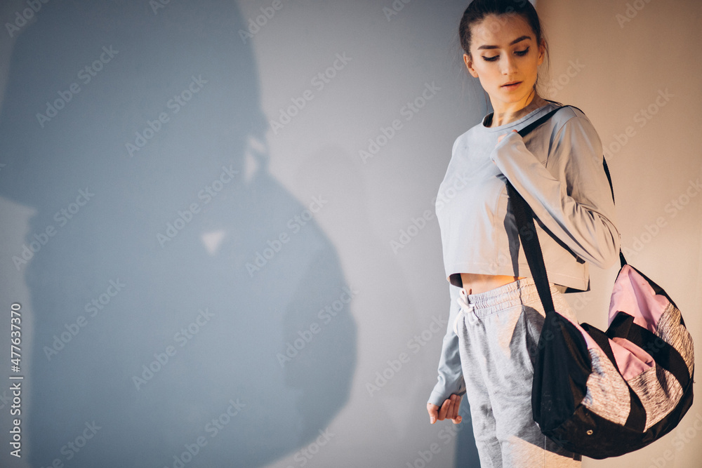 Young woman with sport bag preparing for gym