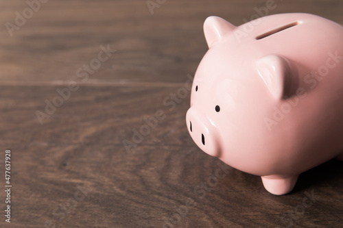 piggy bank on the wooden table © Daniel