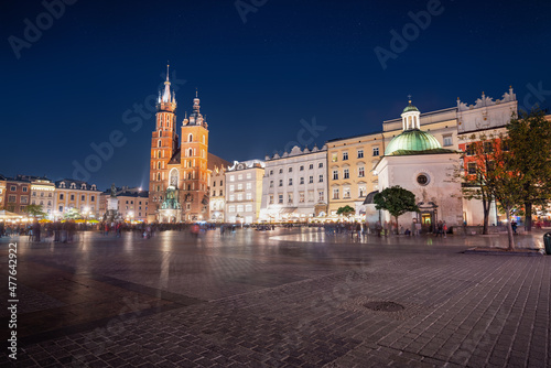 Main Market Square at night with St. Mary's Basilica and Church of St. Wojciech - Krakow, Poland