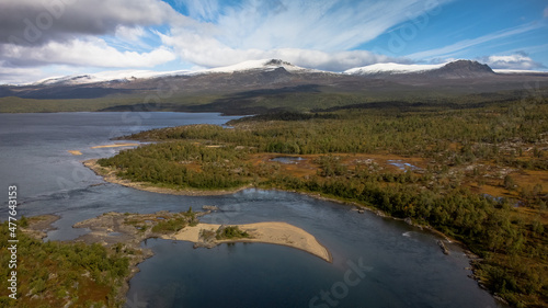 Mighty river and snowy mountains. Scandinavian autumn landscape. Kungsleden trail  Sweden