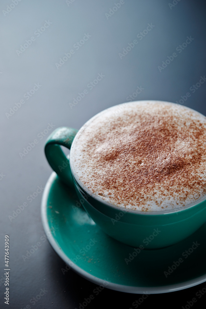 Cinnamon powder close-up on cappuccino