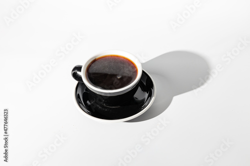 Top view of coffee in black cup with sauce