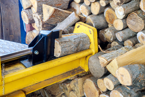 Automated splitter machine equipment by splitting firewood logs photo