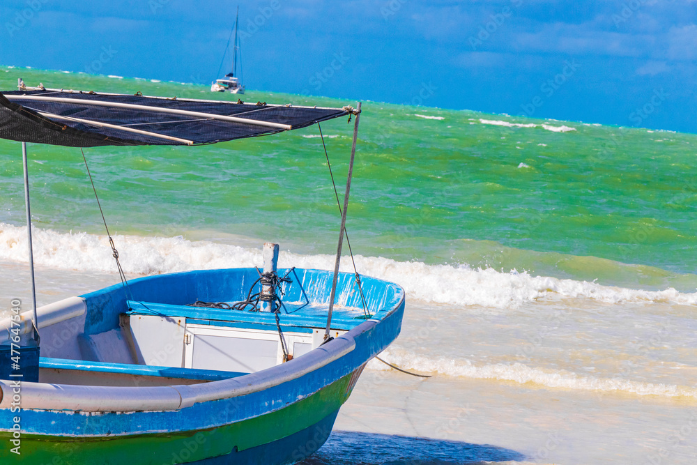 Beautiful Holbox island beach colorful old boat turquoise water Mexico.