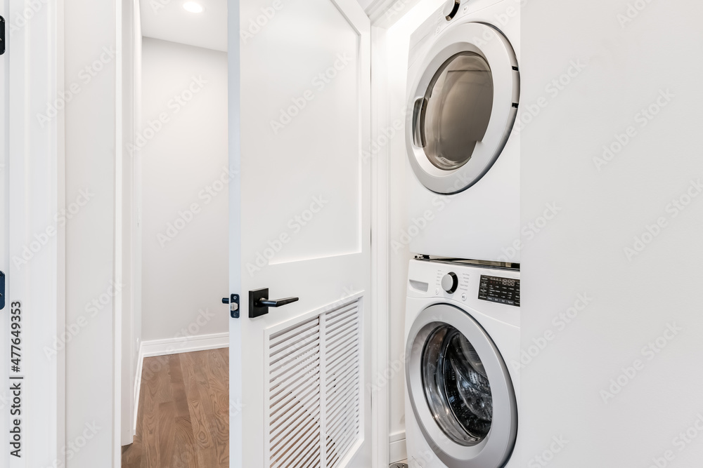 White Stackable Washer and Dryer in Closet