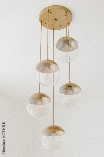 Modern Gold Chandelier Edison Bulb Light Fixture Against White Ceiling