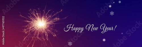 Happy New Year background with glowing sparklers. © Thaut Images