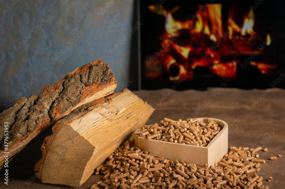 Fototapeta premium Heating a wood stove with pellets in the foreground - an economical concept of the heating system