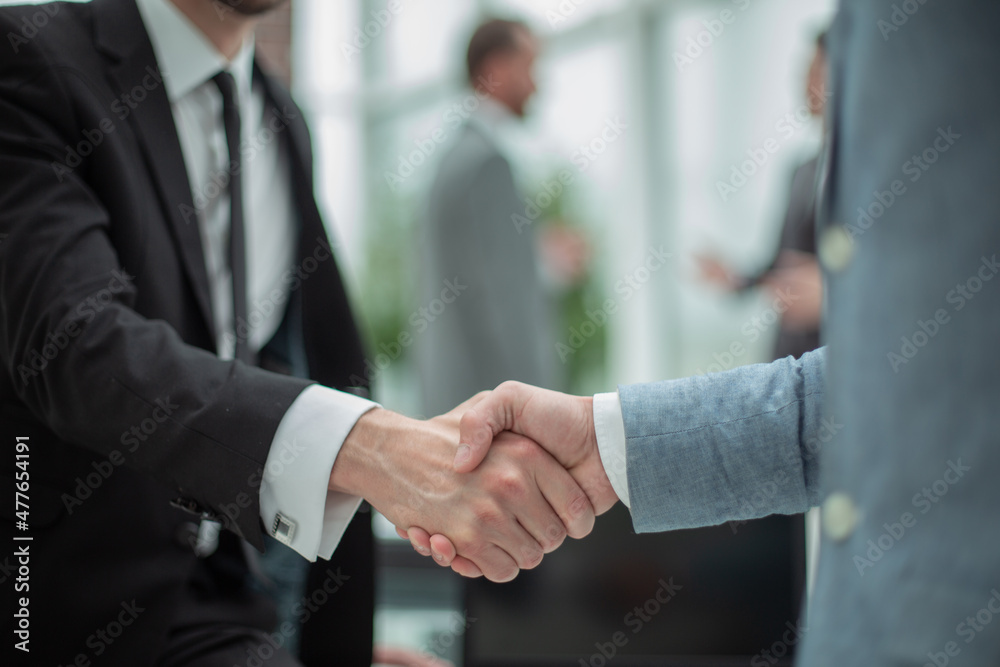 smiling businessman shaking hands with his business partner