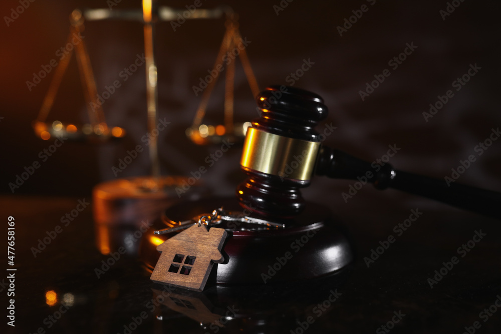 Auction or law concept. House key and judge gavel in notary office Auction or law concept. House key and judge gavel in notary office
