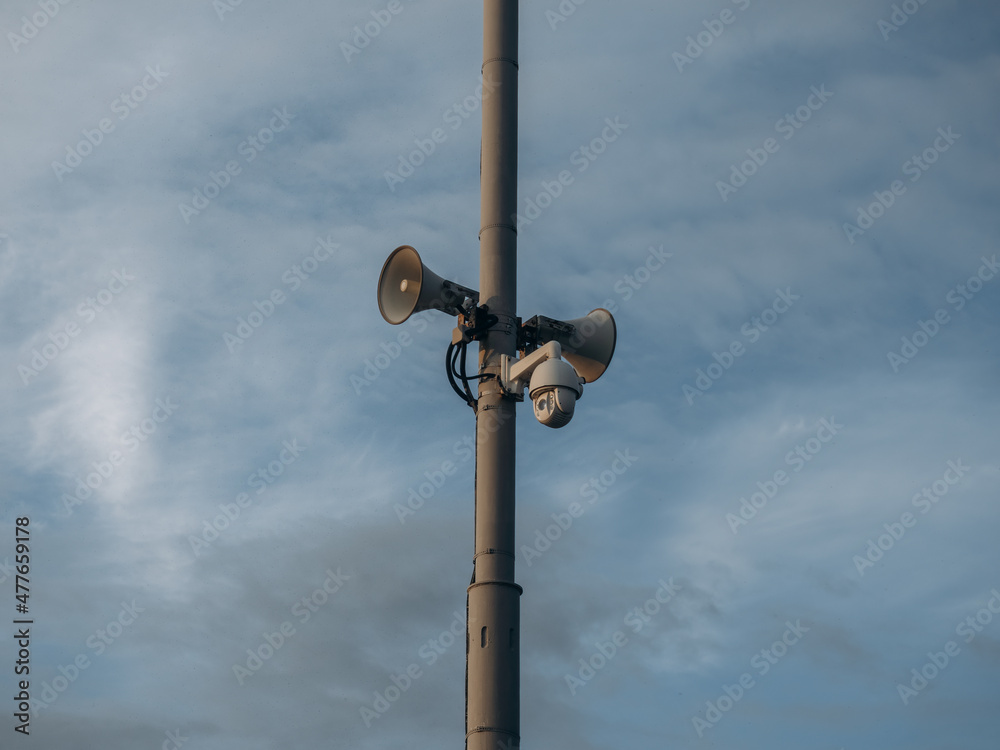 Everything's under control. Viewing black cameras on a column in a public place. Copy space, black speaker and black cameras on the black post.