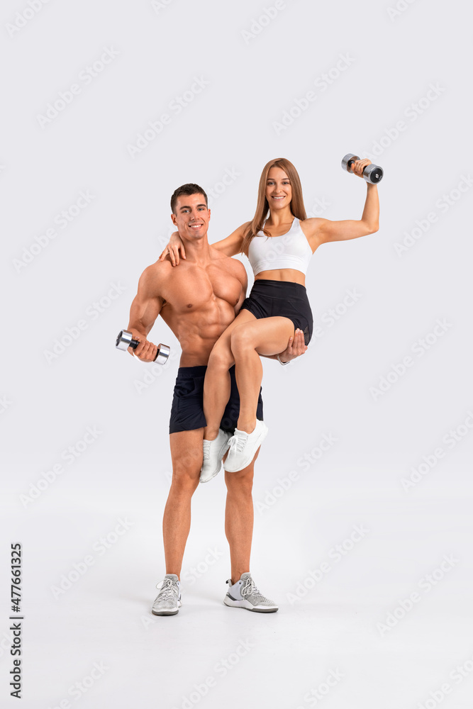 Foto de Fit couple at the gym isolated on white background. Fitness  concept. Healthy life style. do Stock