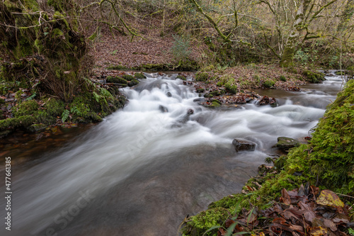 Long exposure of a waterfall on the river Horner in Horner woods in Somerset photo