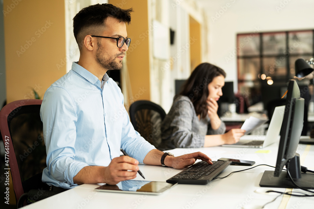 Colleagues in office. Businesswoman and businessman discussing work in office. Colleagues in office. Businesswoman and businessman discussing work in office.