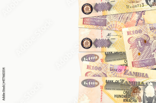 some 100 zambia kwacha bank notes with copyspace to the left on white background